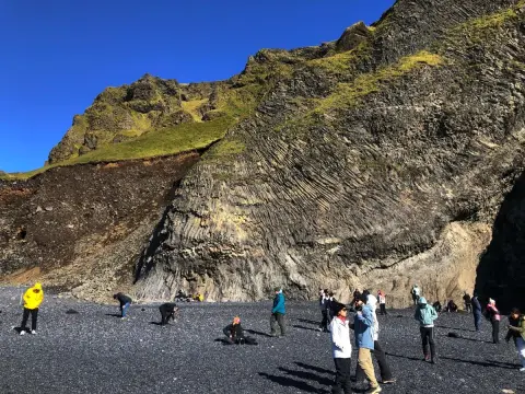Reynisfjara, všichni sbírají oblázky na památku